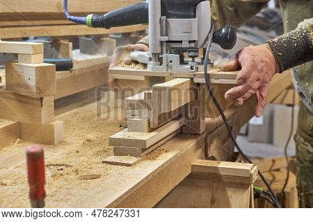 Carpenter Milling Wooden Handrail With Router Manual Milling Machine In Workshop Close Up. Handyman 