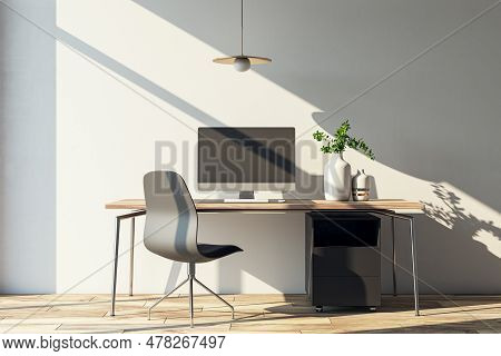 Modern Home Office Interior With Computer, Furniture And Other Items. Concrete Wall With Shadows And