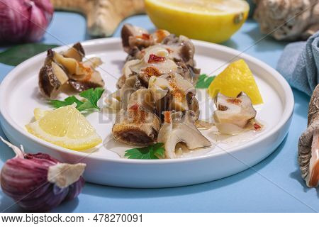 Pickled Rapan Meat With Oil, Spices And Greens. Healthy Seafood Rich Of Omega