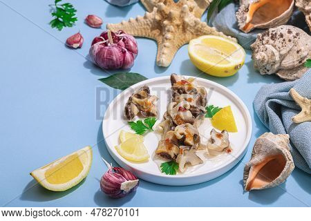 Pickled Rapan Meat With Oil, Spices And Greens. Healthy Seafood Rich Of Omega