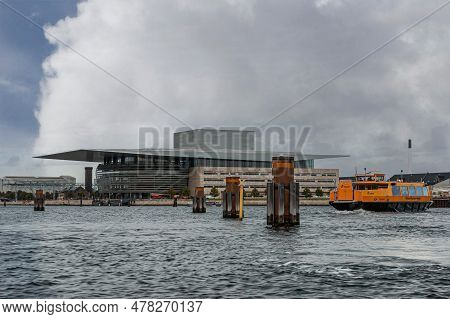 Copenhagen, Denmark - September 14, 2010: Orange Nyhavn-opera Ferry On Gray Water With South And Wes