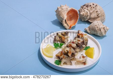 Pickled Rapan Meat With Oil, Spices And Greens. Healthy Seafood Rich Of Omega