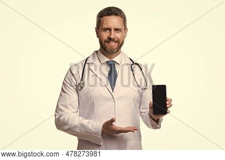 Medical Application. Happy Man Doctor Presenting Medical Phone Application. Emedicine In Your Phone