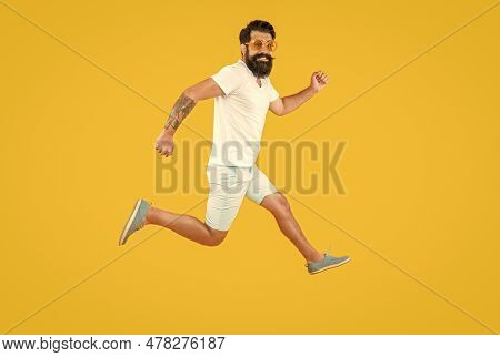 Hurrying Man Isolated On Yellow. Hurrying Man In Studio. Hurrying Man On Background.