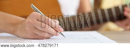 Close-up Of Female Hand Writing Notes Of New Song. New Ideas Inspirational Singer Composing Music Wi