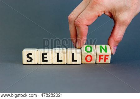 Sell On Or Off Symbol. Businessman Turns Wooden Cubes And Changes Word Sell Off To Sell On. Beautifu