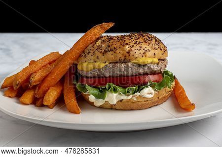 Hamburger On An Everthing Brioche Bun  Served With Sweet Potato Fries,