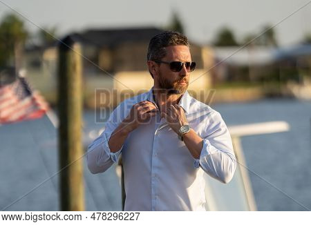 Millennial 40s Man Near The Yacht. Portrait Of Fashion Model Outdoor. Fashion Male Posing Near Yacht