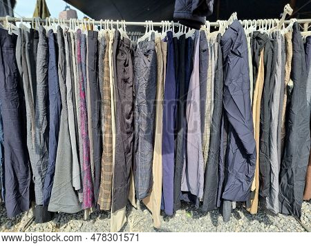 Second-hand Trousers Were Hung On The Rack. In One Of The Second-hand Markets In Thailand.
