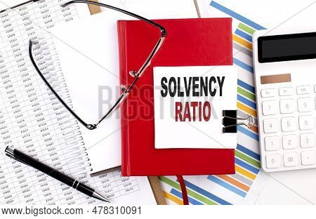 Solvency Ratio Text On A Notebook With Chart, Calculator And Pen