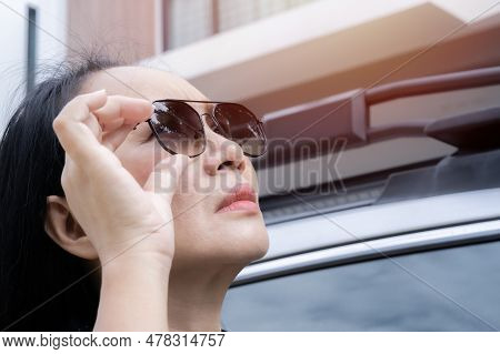 Side View Of Beautiful Mature Woman Wearing Sunglasses At Home And Getting Ready To Drive To Work Ou
