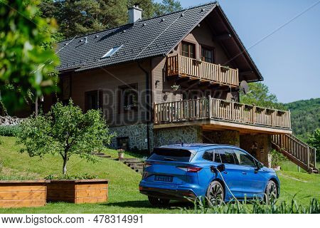 Close Up Of Electric Car Chaging In A Family Garden.