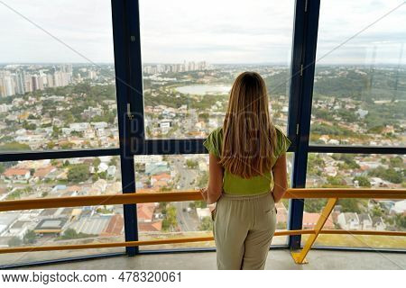 Back View Of Young Woman Looking Curitiba Cityscape From Torre Panoramica The Panoramic Tower Of Cur