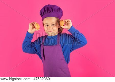 Child Cook Hold Eggs. Child Cooking, Little Chef Prepares Food. Kid Boy In Chefs Hat And Apron On Pi