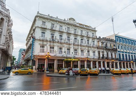 Havana, Cuba - October 21, 2017: Havana Ctyscape With Yellow Taxi Car In Background And Hotel. Centr