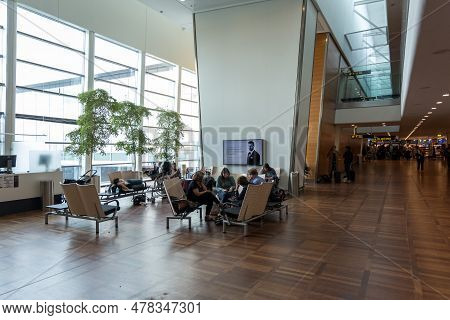 Copenhagen, Denmark - August 24, 2017: Copenhagen International Airport Kastrup. People Sitting On T