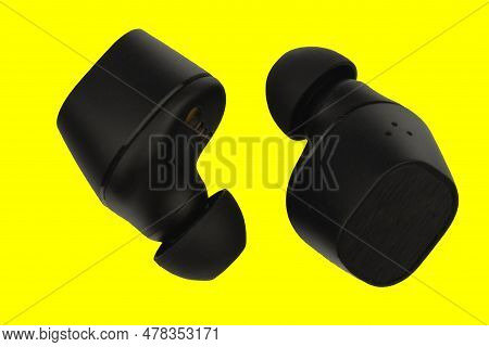 Wireless Stereo Earbuds. Black Wireless Earphones. Earbuds Or Headphones Isolated On Yellow Backgrou