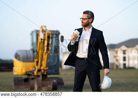 Construction Manager In Suit And Helmet At A Construction Site. Construction Manager Worker Or Super