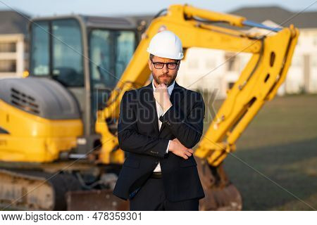 Construction Business Owner. Man In Suit And Hardhat Halmet At Building Construction Site. Civil Eng