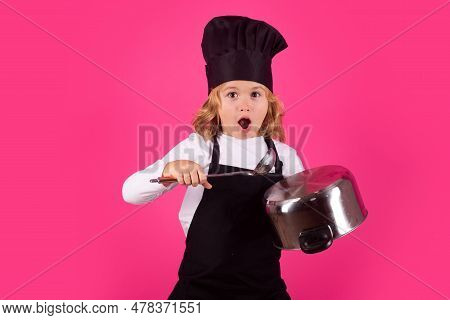 Fynny Kid Chef Cook With Cooking Pot And Ladle. Chef Child Preparing Healthy Food. Studio Portrait O