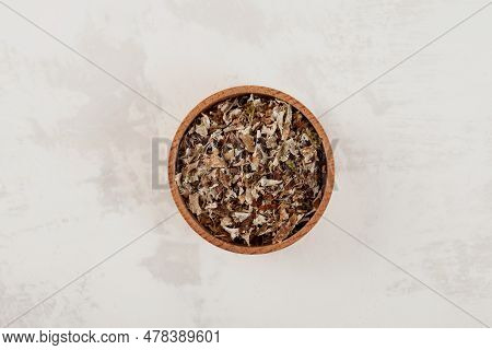 Iceland Moss In Wooden Bowl On Grey Background, Top View, Selective Focus. Crushed Dried  Arctic-alp