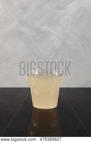 Pomada Drink In Disposable Plastic Cup On Grey Background. Refreshing Iced Cocktail With Gin And Lem