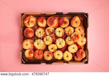 Fig Peaches In Paper Box On Pink Background, Top View. Crop Peaches. Season Fruits.