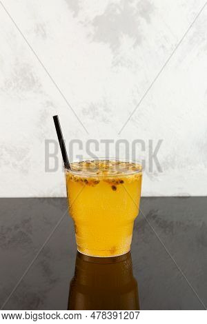 Iced Yuzu Drink With Passion Fruit And Orange Juice In Disposable Plastic Cup. Take Away Food And Dr