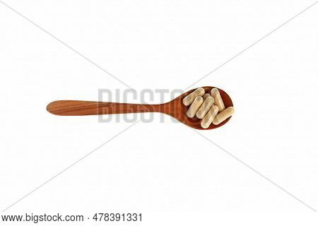 Hulbah Pills In Wooden Spoonon White Background, Top View. Hulbah Pills Soothe Upset Stomach And Dig