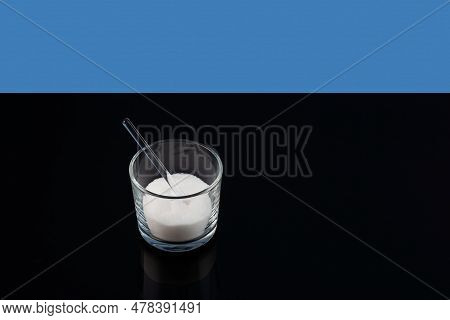 Konjac Gum Powder In Glass On Dark Table, Selective Focus, Copy Space. Food Additives E425 Used In M