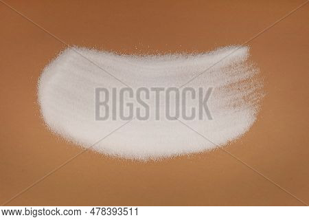 Pile Of Sugar Substitute Xylitol Or Birch Sugar Scattered On Brown Surface. Food Additive E967, Swee