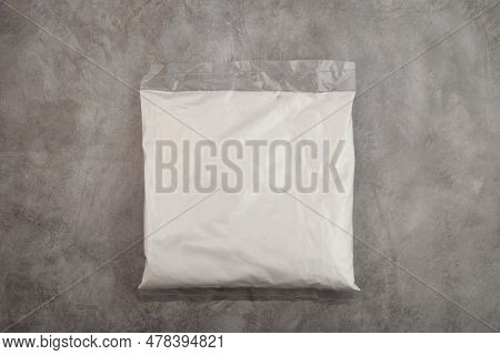 Succinic Acid Powder In Plastic Bag On Grey Background. Butanedioic Acid Or Spirit Of Amber. White P
