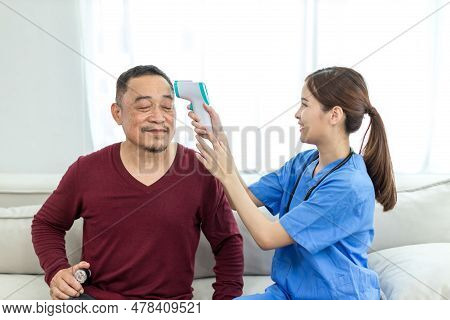 Caregiver Nurse Take Care A Senior Patient Sit On Sofa At Home. Nurse Helping Senior People