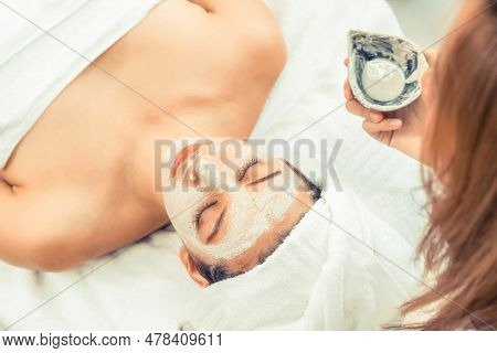 Beautiful Woman Having A Facial Cosmetic Scrub Treatment From Professional Dermatologist At Wellness