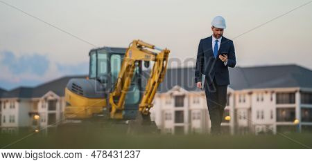 Construction Business Owner. Man In Suit And Hardhat Halmet At Building Construction Site. Civil Eng