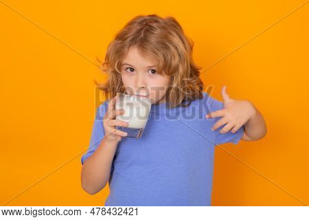 Organic Milk. Child With A Glass Of Milk On Studio Background. Cute Boy In White Shirt Holding Glass