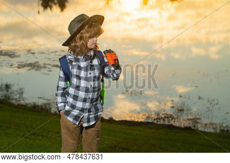 Scout Boy Wearing Explorer Hat And Backpack Outdoor. Explorer And Adventure With Binocular.