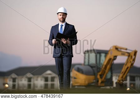 Construction Business Owner. Man In Suit And Hardhat Halmet At Building Construction Site. Civil Eng