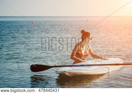 Sea Woman Sup. Silhouette Of Happy Middle Aged Tanned Woman In Rainbow Bikini, Surfing On Sup Board,