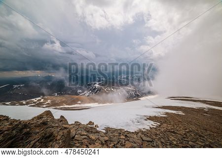 Awesome Top View Through Clouds To High Snowy Mountains. Scenic Landscape With Beautiful Snow Mounta