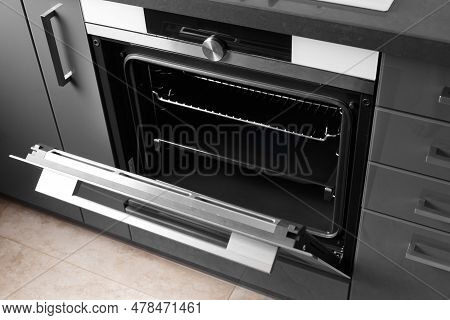 Built-in Electric Oven With An Open Door In The Interior Of The Kitchen. Oven With Display, Convecti