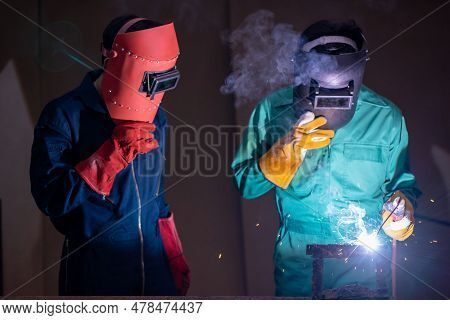 Metal Welding Steel Works Using Electric Arc Welding Machine To Weld Steel At Factory. Metalwork Man