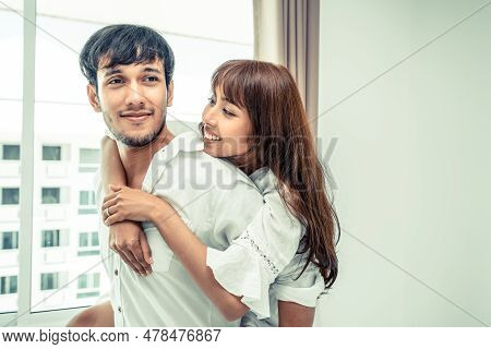 Happy Young Couple Relaxing At Home In The Morning.