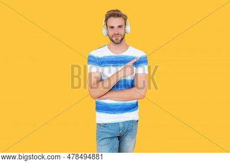 Estudy Man Uses Headphones Isolated On Yellow Background, Pointing Finger. Young Estudy Man Attends 