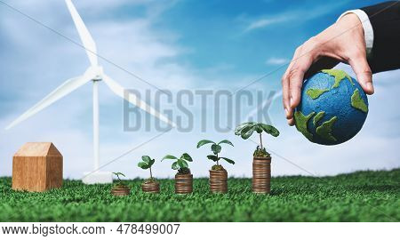 Eco Business Invest On Environment Conservation Subsidize, Coin Stack With Grow Seedling, Hand Holdi