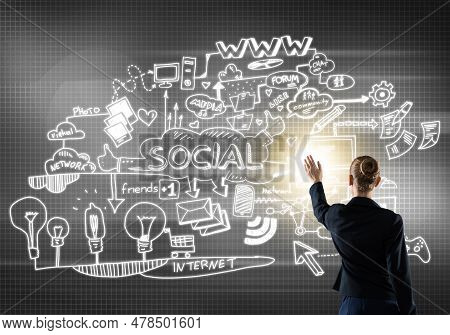 Rear View Of Businesswoman And Sketches Of Social Media Communcation Concept