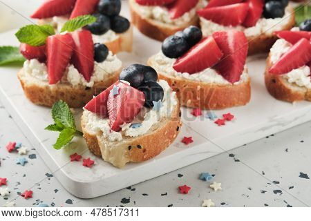 American Flag Sandwich With Strawberries, Blueberries, Whipped Sweet Cream, Soft Cheese On Toast Bre