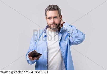 Worried Moneyless Man With Wallet Isolated On Studio Background. Moneyless Man