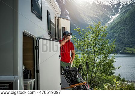 Caucasian Rv Owner Drinking Morning Coffee Inside A Camper Van Right Before Heading Mountain Trail W