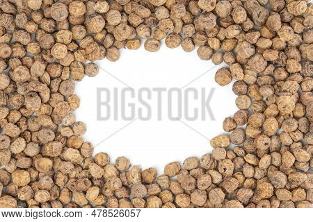 Top View Of A Of Tigernuts On A White Background With Copy Space In The Middle